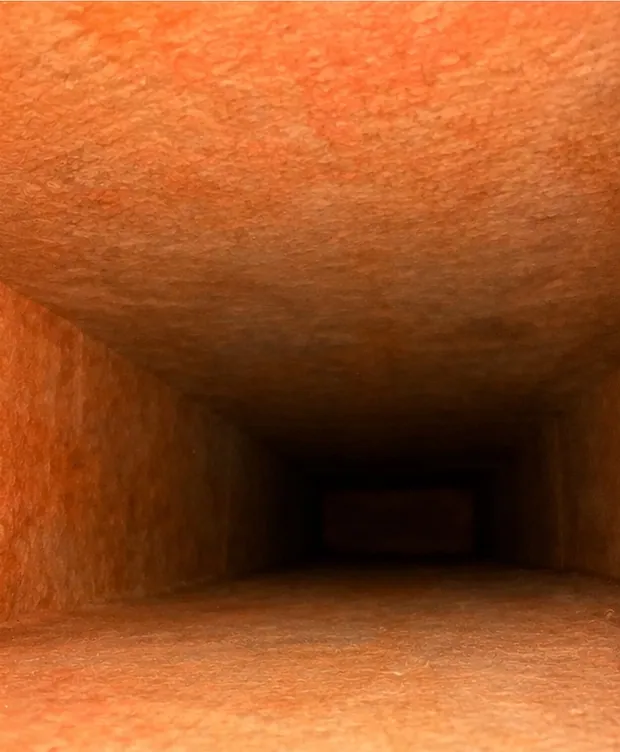 The same duct after cleaning: the liner back to its clean orange